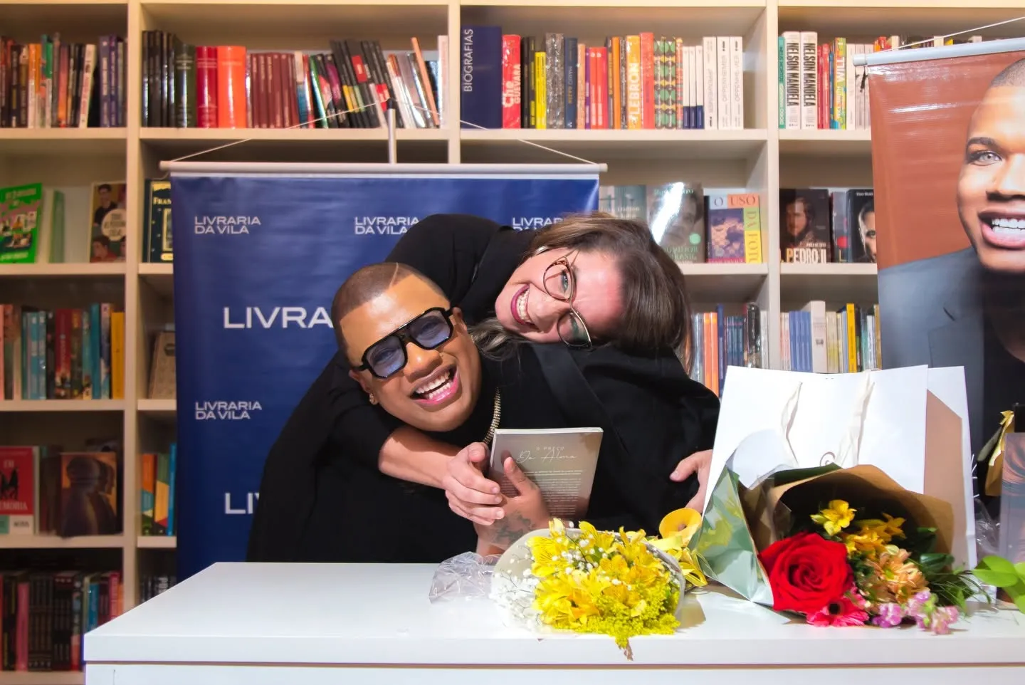 Lançamento do livro O Preço da Alma — autor abraçado por convidada sorridente